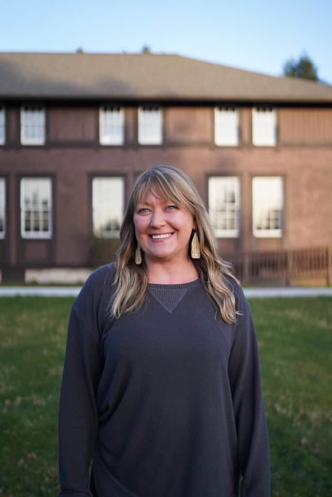 A woman standing in front of a building.