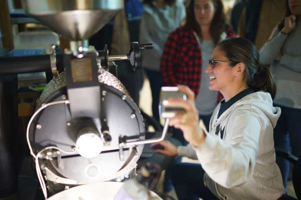 At Skya’ana Coffee Co., Tina is house roasting and serving quality coffee in her community. She is roasting beans here.