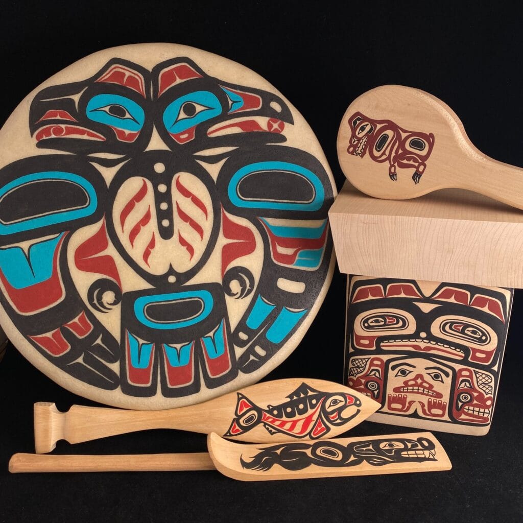 A set of native art pieces including a drum, a bowl and a spoon.