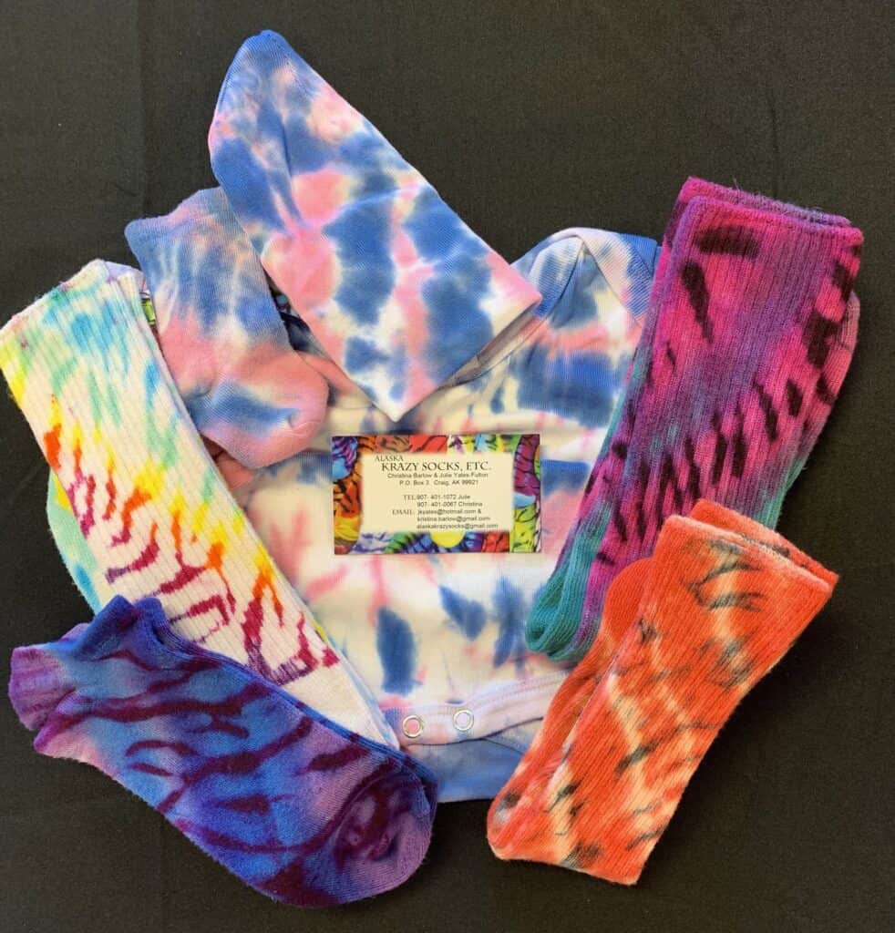 Tie dye socks with a tag and a card.