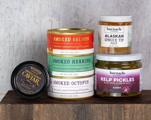 A variety of different types of tinned fish and pickles.